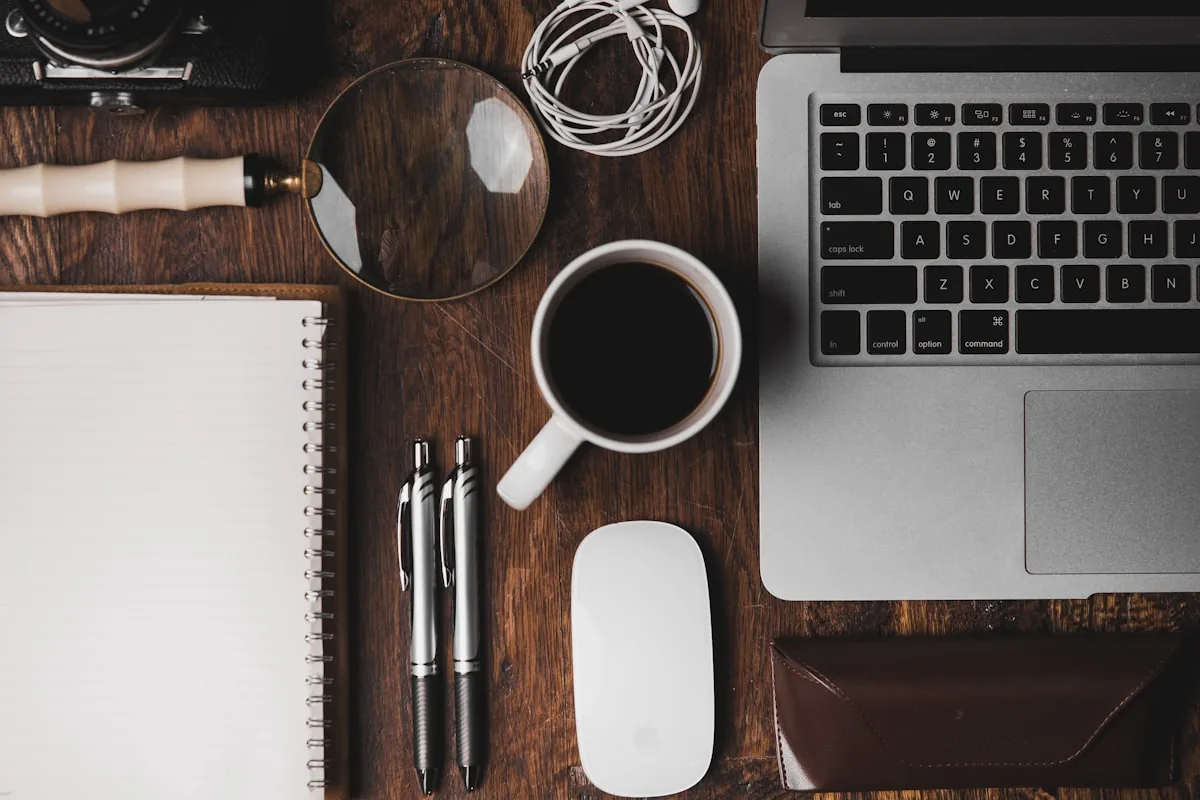 Workspace with a laptop, notebook and coffee